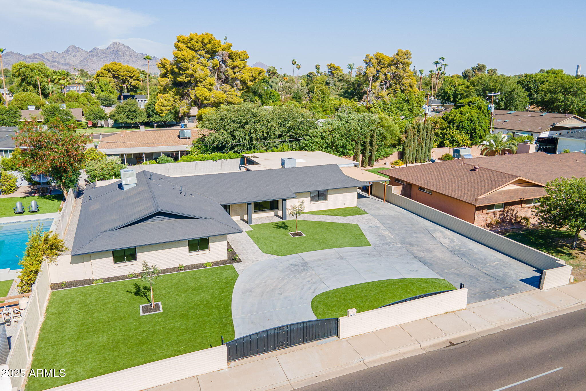 an aerial view of a house with a yard