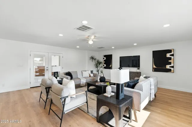 a living room with furniture or couch and a potted plant