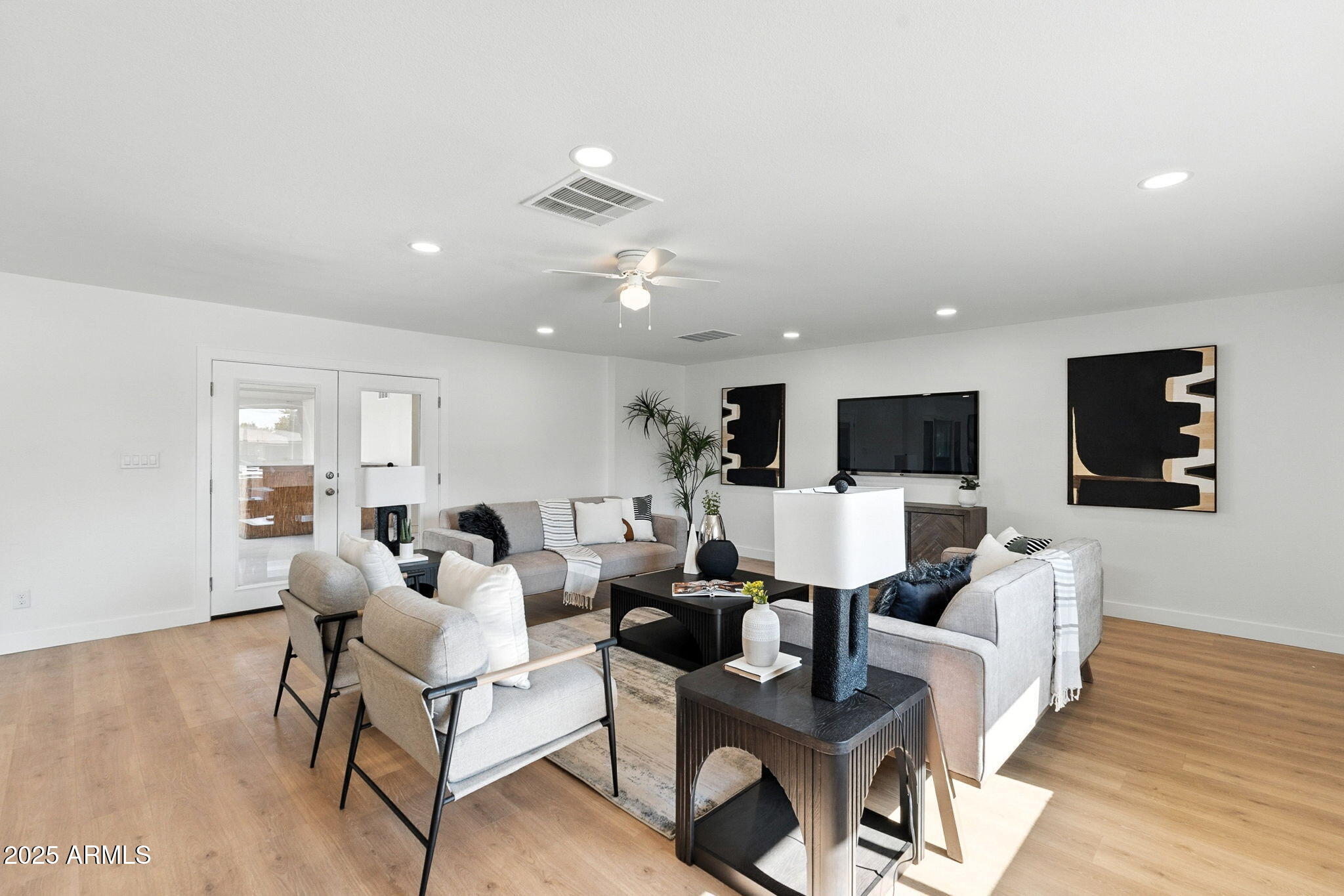 7637 North 7th Avenue Phoenix, AZ 85021 - Photo 11 of 57 a living room with furniture and a flat screen tv