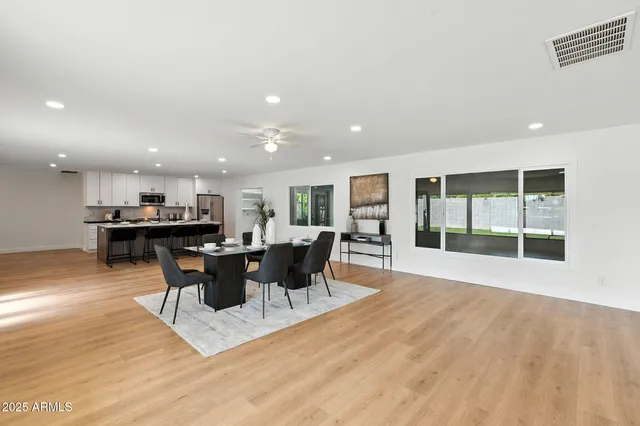 a view of a dining room with furniture and a potted plant