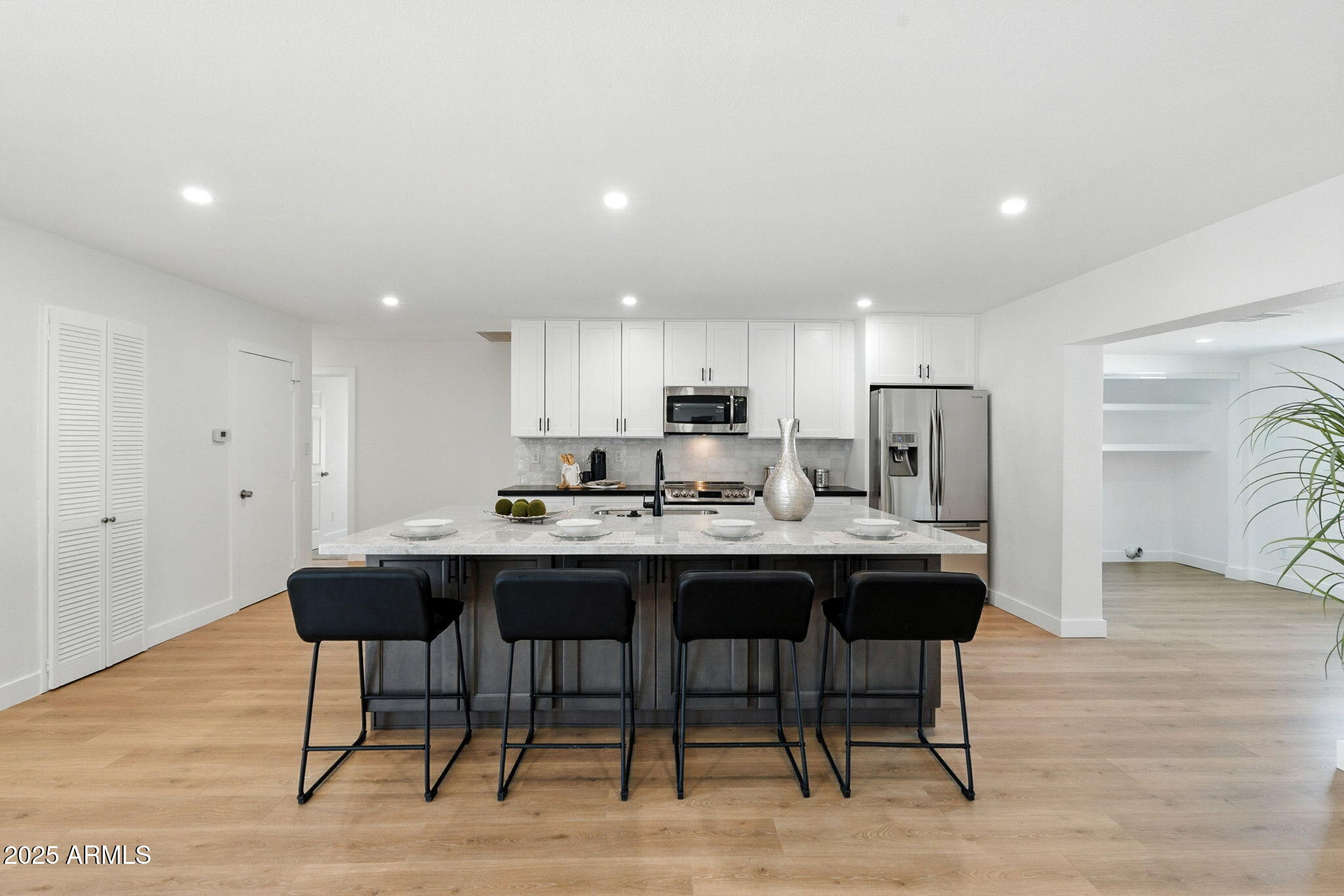 7637 North 7th Avenue Phoenix, AZ 85021 - Photo 20 of 57 a kitchen with stainless steel appliances granite countertop a table chairs sink and cabinets