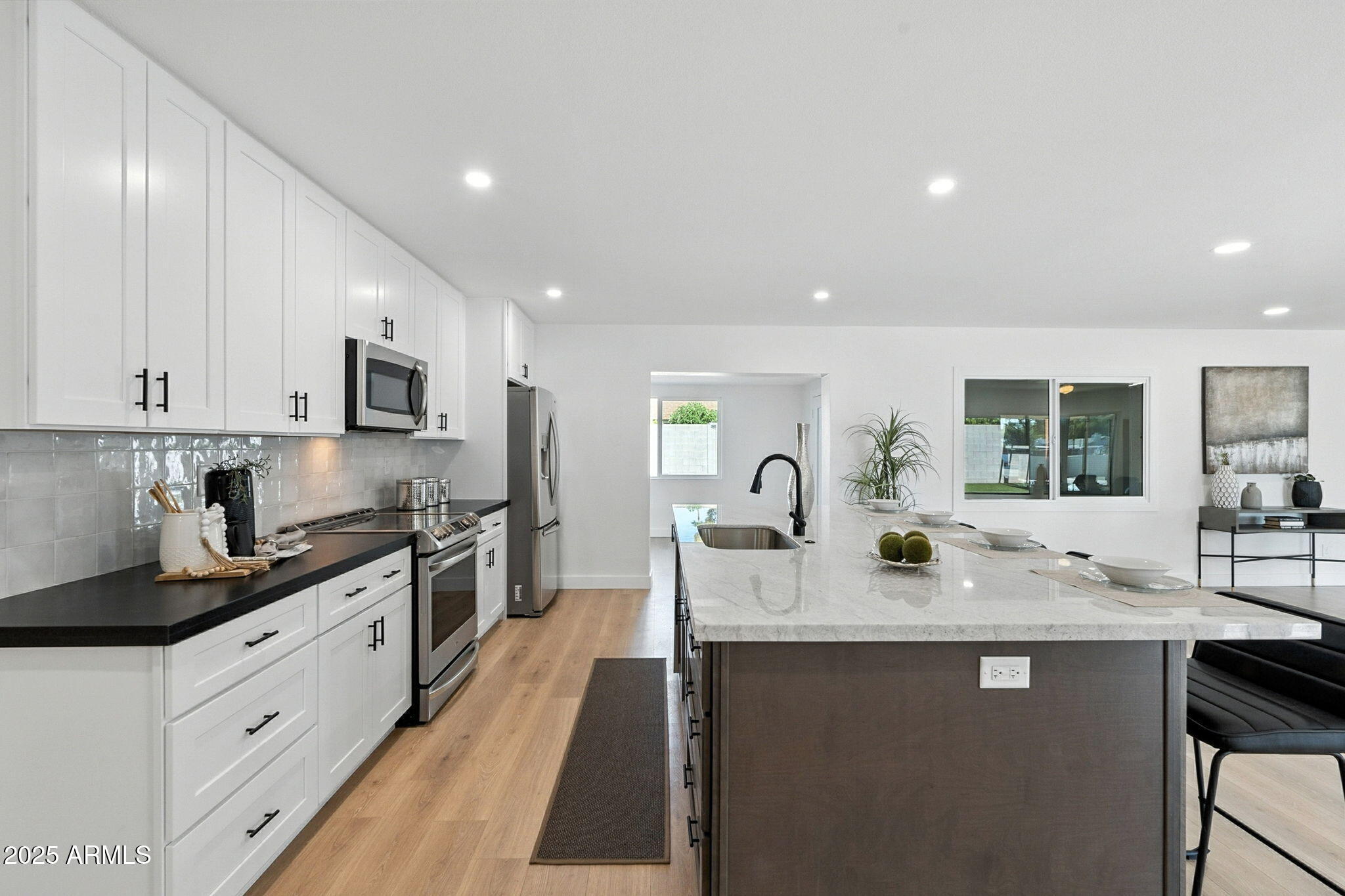 7637 North 7th Avenue Phoenix, AZ 85021 - Photo 24 of 57 a kitchen with stainless steel appliances granite countertop a sink stove and cabinets