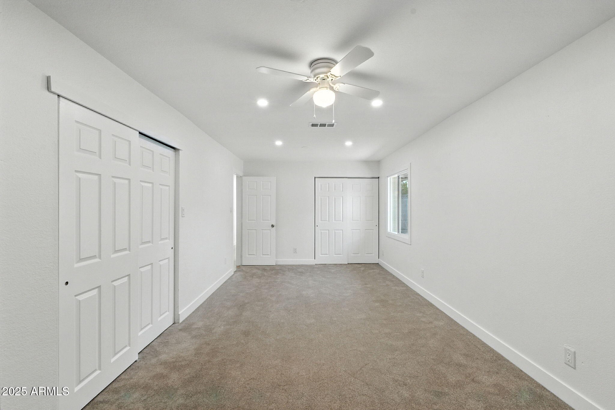 7637 North 7th Avenue Phoenix, AZ 85021 - Photo 28 of 57 an empty room with a ceiling fan and window