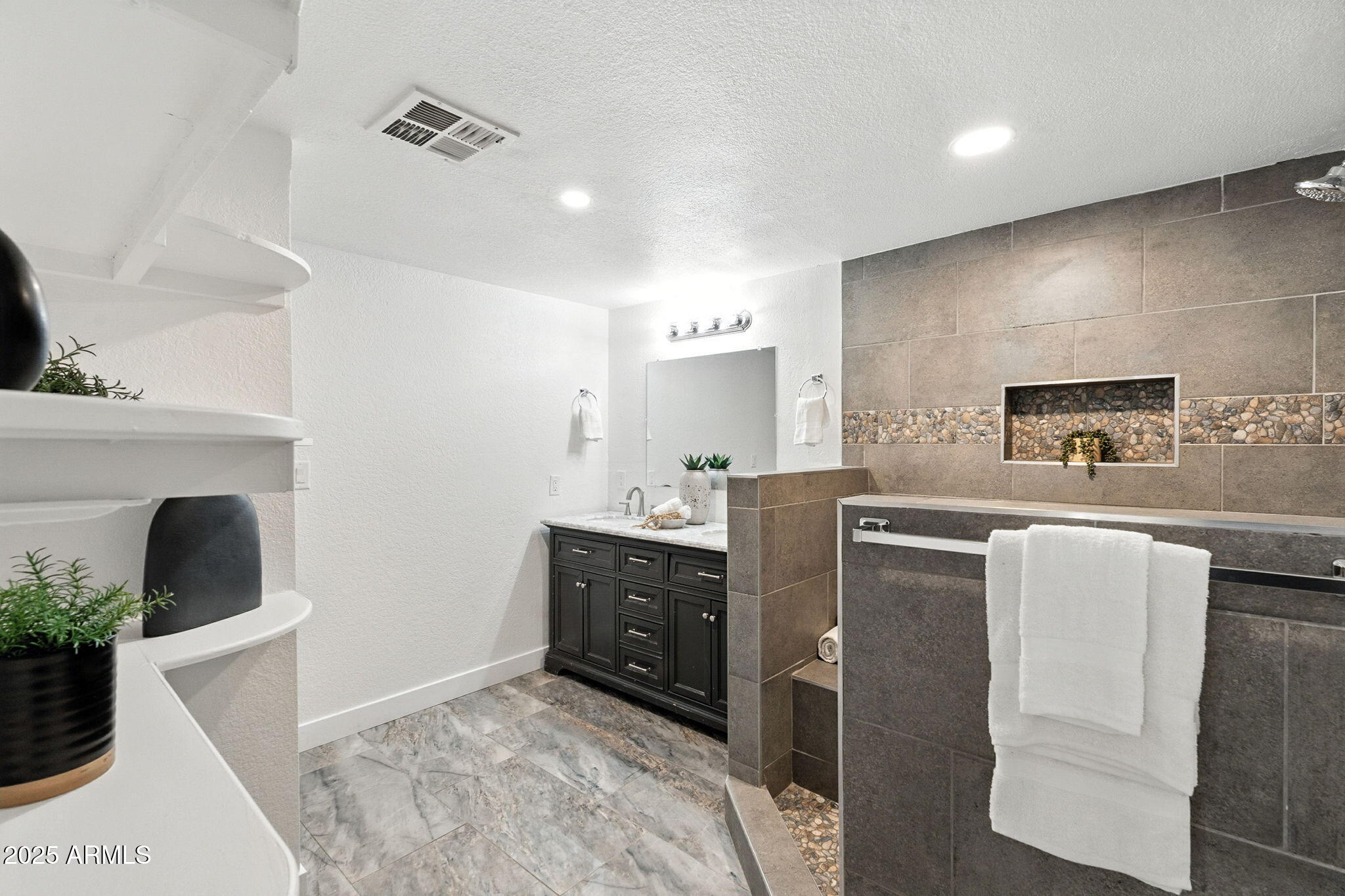 7637 North 7th Avenue Phoenix, AZ 85021 - Photo 29 of 57 a kitchen with stainless steel appliances kitchen island granite countertop a refrigerator a sink a stove and white cabinets
