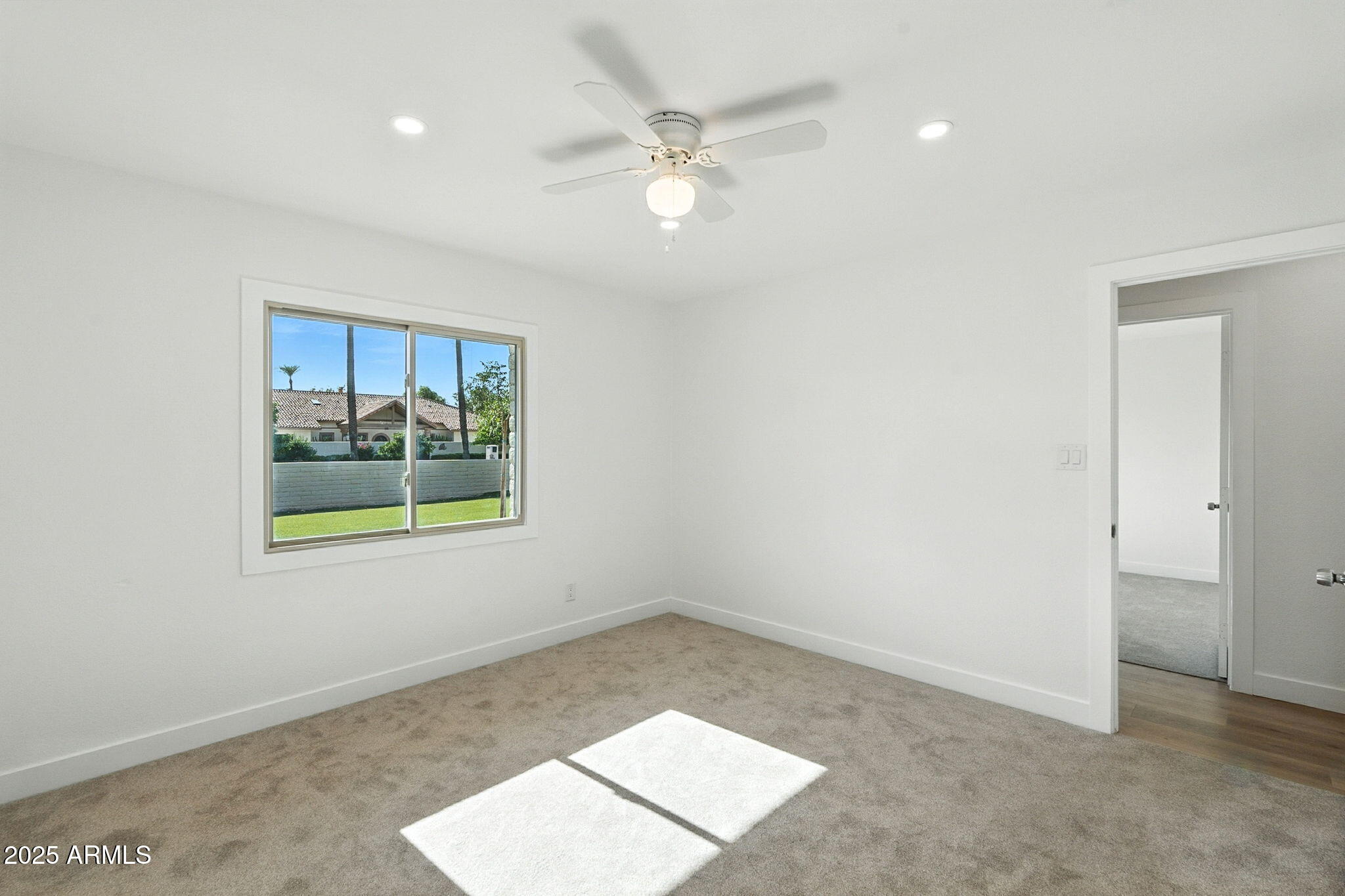 7637 North 7th Avenue Phoenix, AZ 85021 - Photo 37 of 57 an empty room with a window and a ceiling fan
