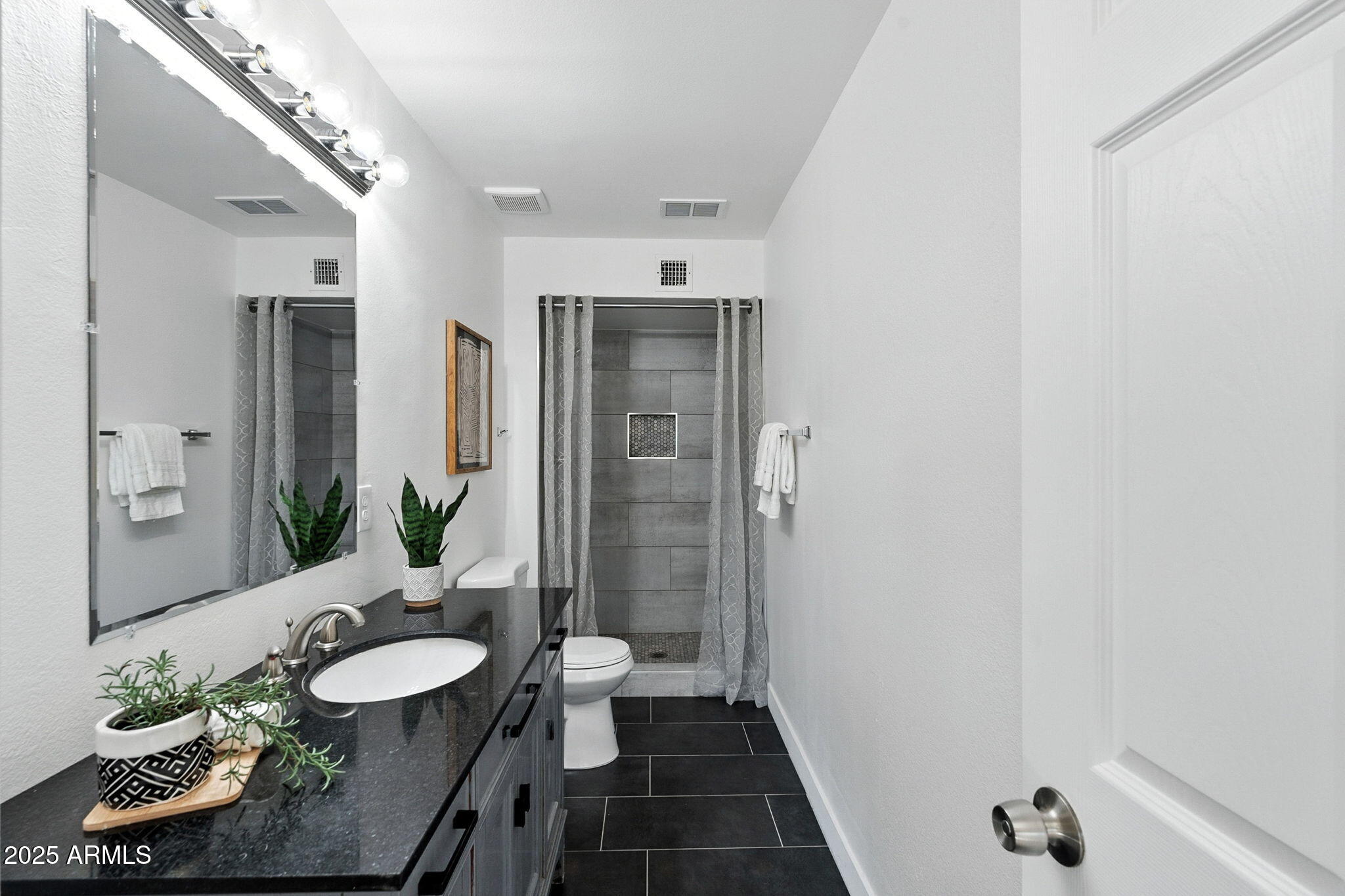 7637 North 7th Avenue Phoenix, AZ 85021 - Photo 39 of 57 a bathroom with a double vanity sink and a mirror