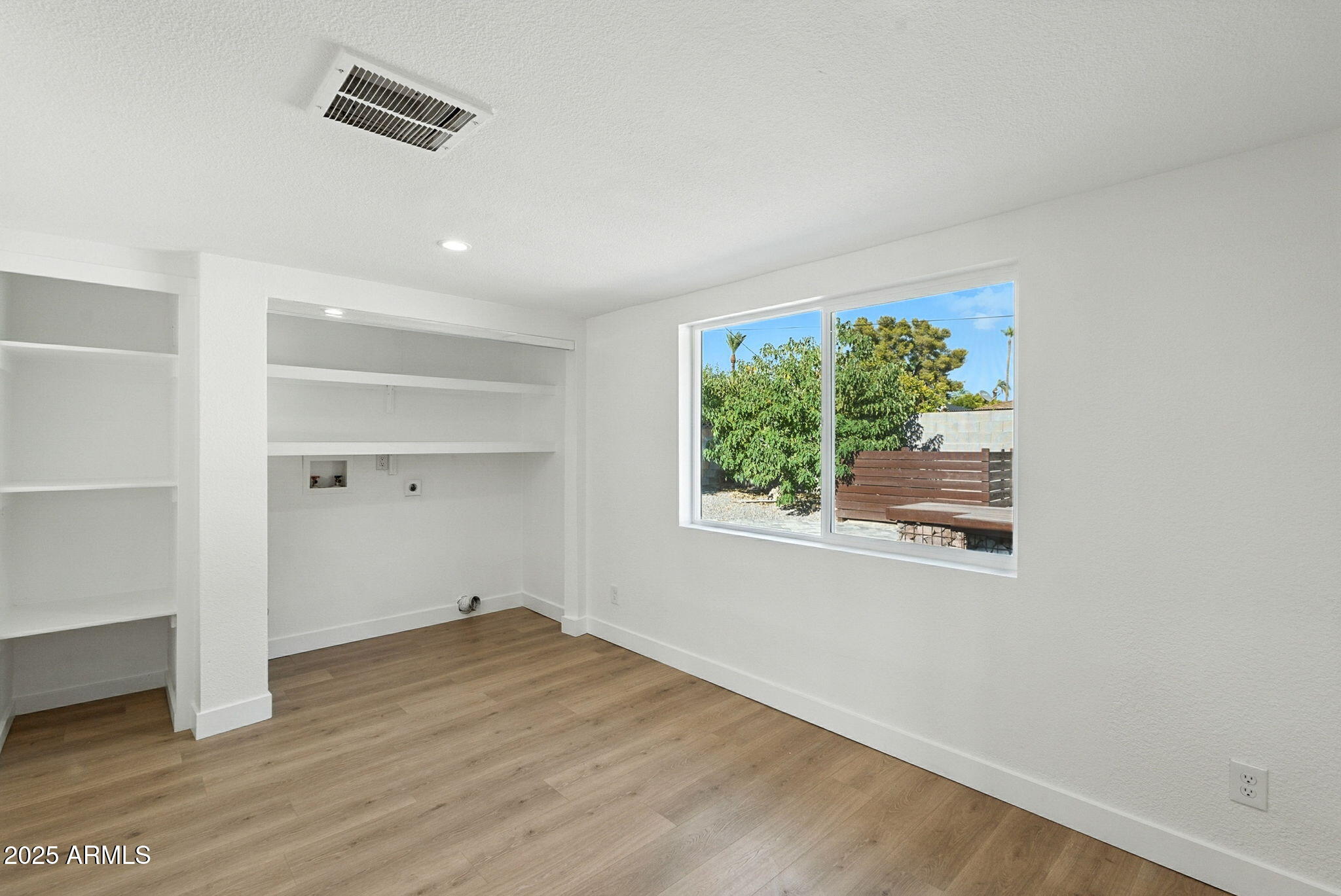 7637 North 7th Avenue Phoenix, AZ 85021 - Photo 41 of 57 an empty room with wooden floor and windows