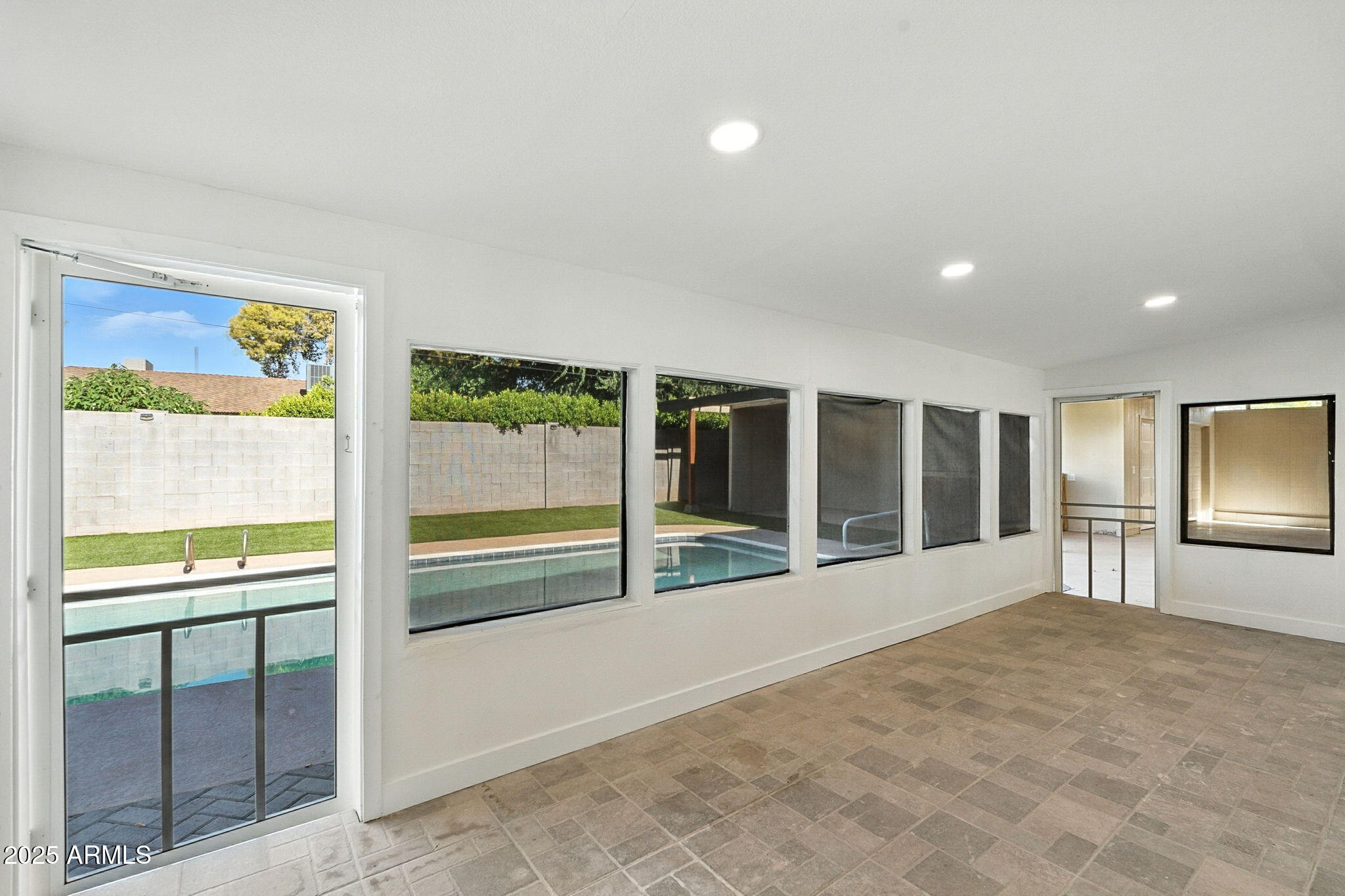 7637 North 7th Avenue Phoenix, AZ 85021 - Photo 43 of 57 a view of an empty room with a window and a kitchen