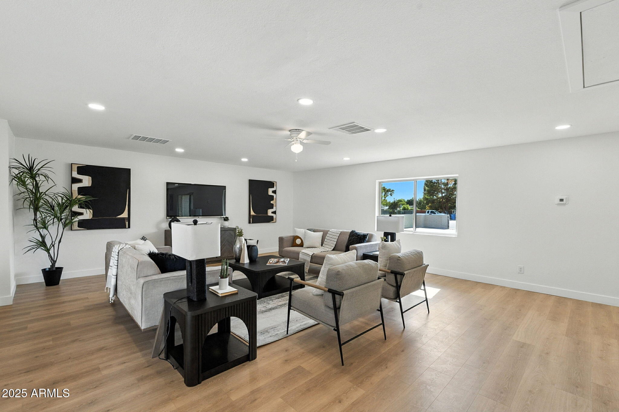 7637 North 7th Avenue Phoenix, AZ 85021 - Photo 10 of 57 a living room with furniture a flat screen tv and a potted plant