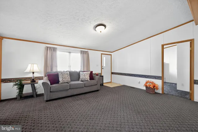 a living room with furniture and flowers