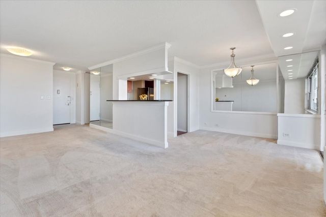 a view of a kitchen with a sink and a refrigerator