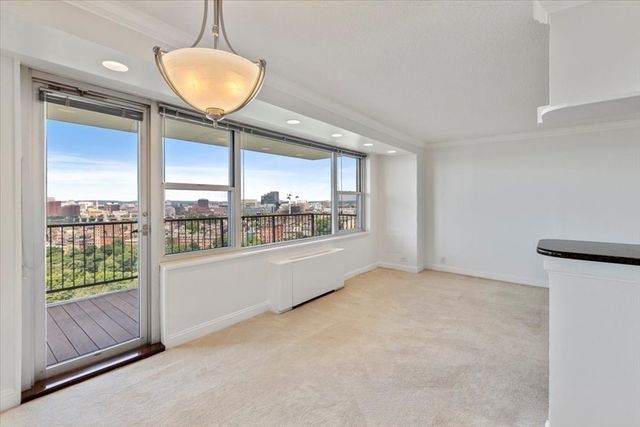 a view of an empty room with a window and storage