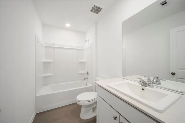 a bathroom with a sink toilet vanity and shower