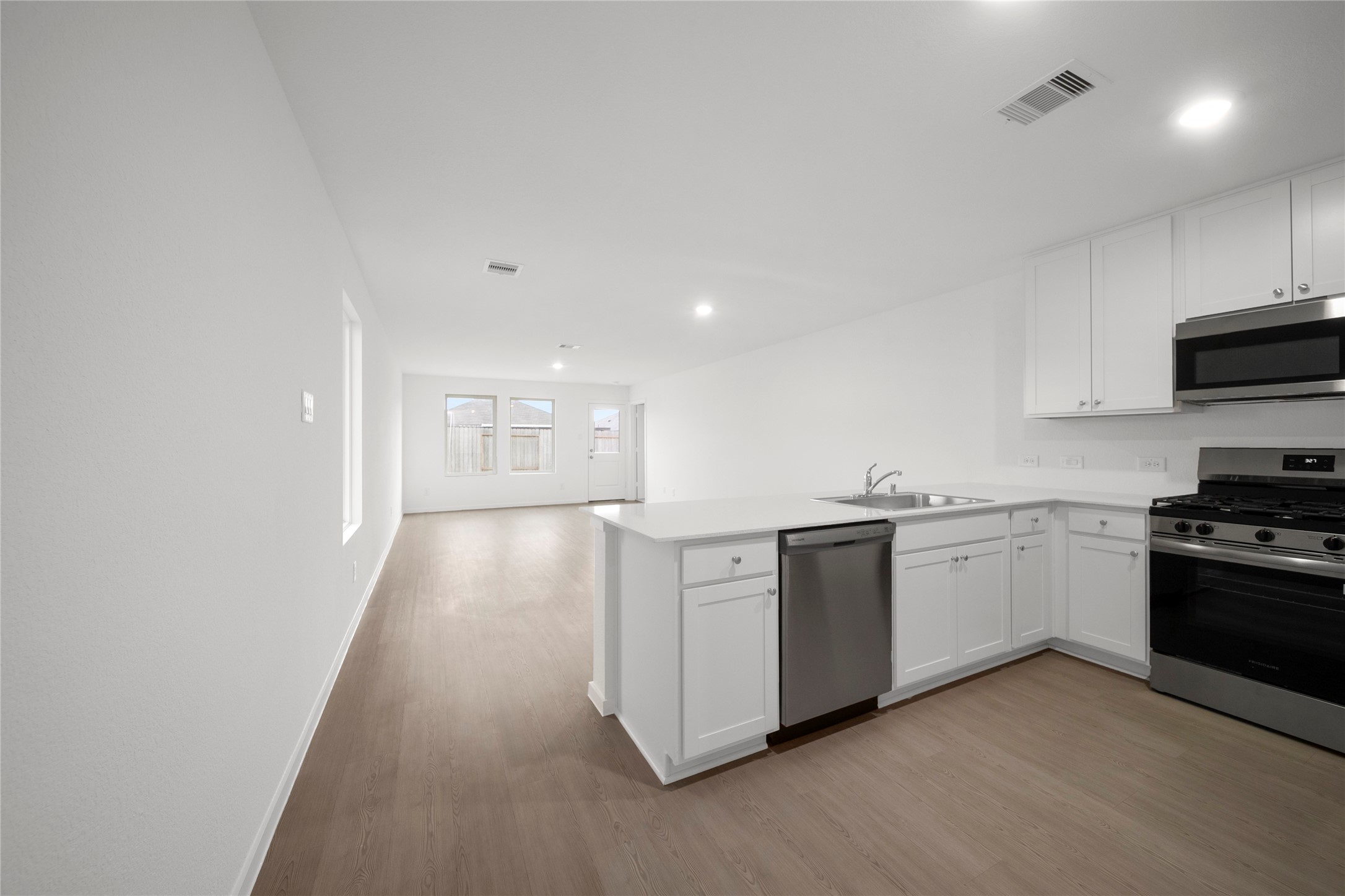 31436 Moore Road Magnolia, TX 77354 - Photo 3 of 25 a kitchen with stainless steel appliances granite countertop a stove a sink and a refrigerator