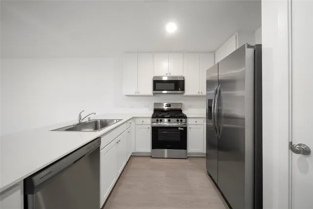 a kitchen with a sink and stainless steel appliances