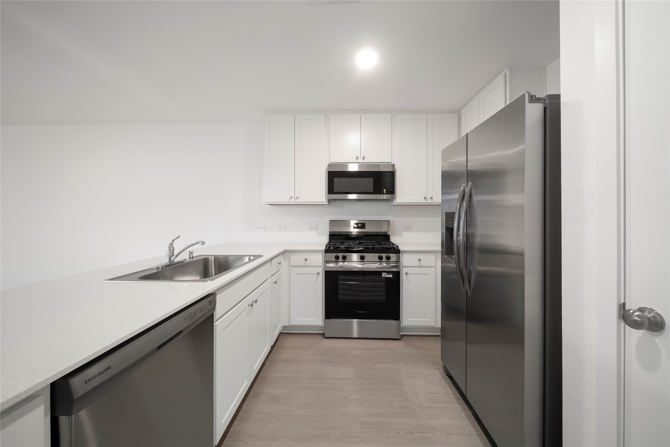 31436 Moore Road Magnolia, TX 77354 - Photo 4 of 25 a kitchen with a sink and stainless steel appliances
