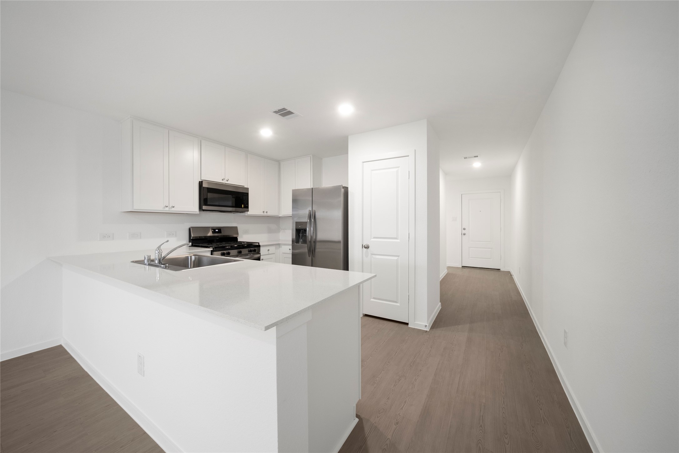 31436 Moore Road Magnolia, TX 77354 - Photo 6 of 25 a kitchen with stainless steel appliances a refrigerator stove microwave and sink