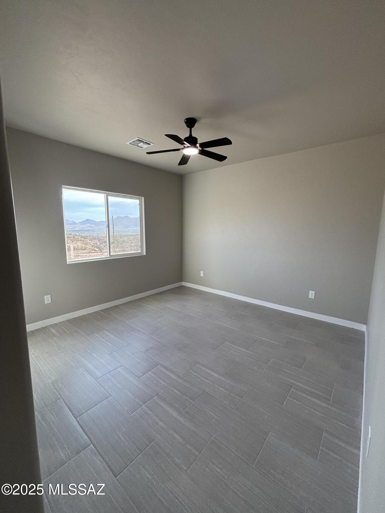 233 Canasta Court Rio Rico, AZ 85648 - Photo 7 of 10 a view of a livingroom with a ceiling fan and window