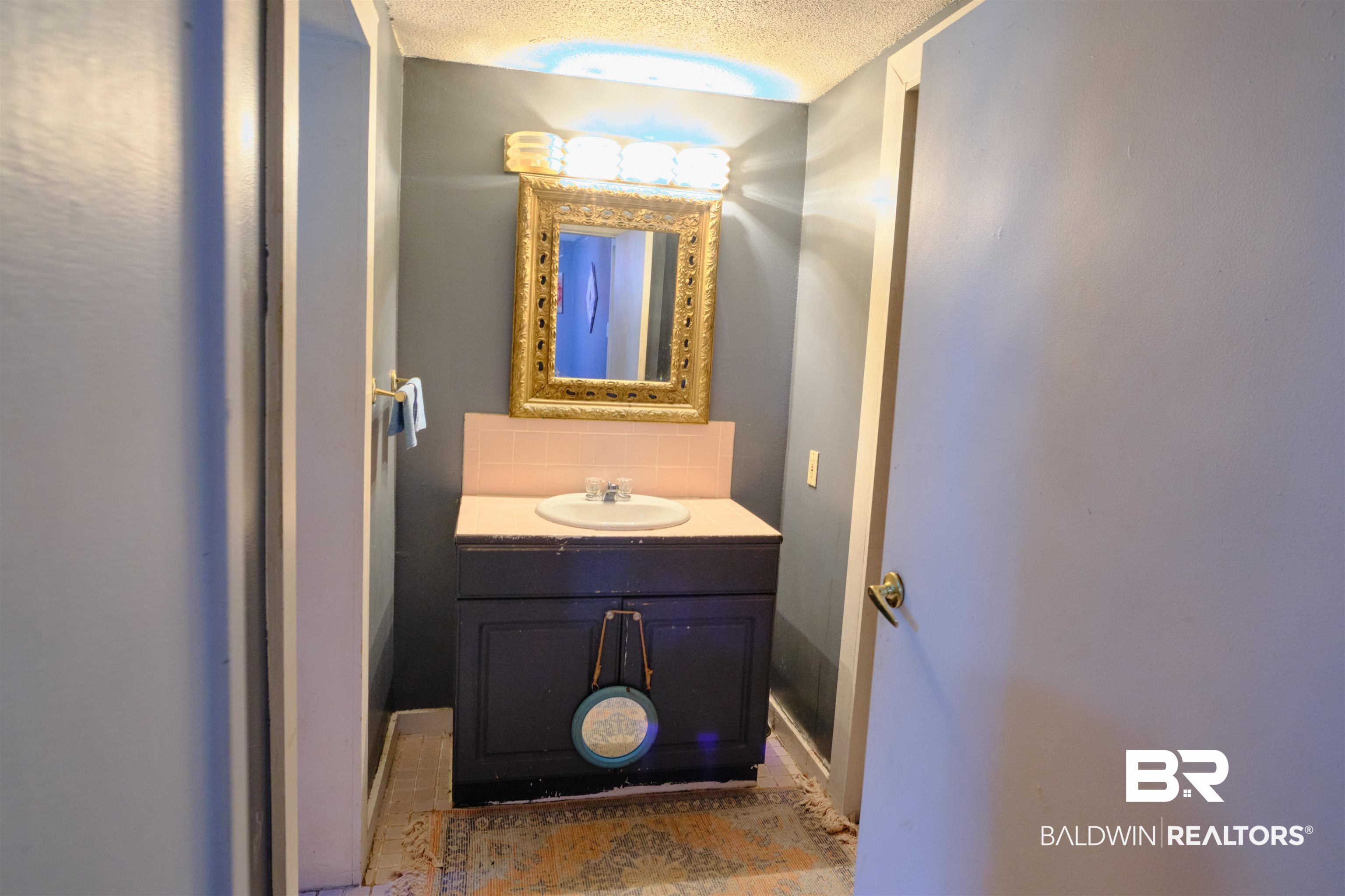 101 West Horner Street Atmore, AL 36502 - Photo 35 of 38 Bathroom with vanity and a textured ceiling