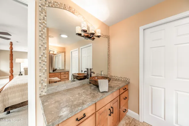 a bathroom with a tub a window and glass door shower