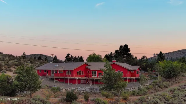 a view of a house with a backyard and porch