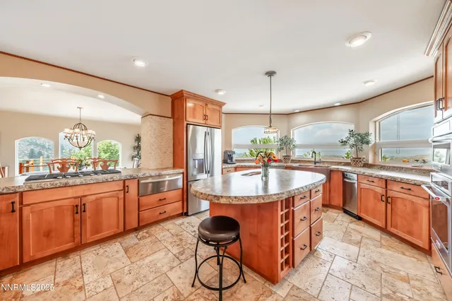 a kitchen with stainless steel appliances granite countertop a sink and cabinets