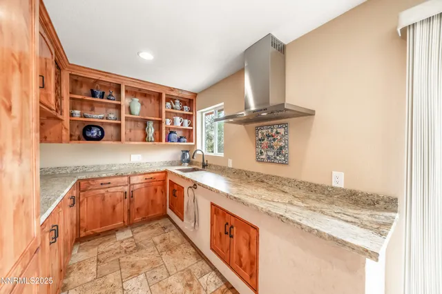 a bathroom with a granite countertop sink mirror and vanity