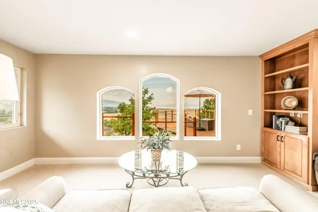 a living room with fireplace furniture and a window