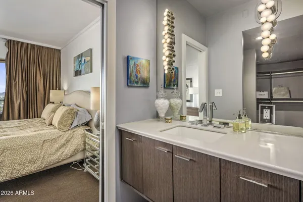 a bedroom with a bed and a large window