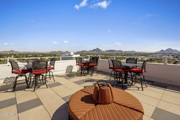 a view of a kitchen with stainless steel appliances granite countertop center island wooden floor and a window
