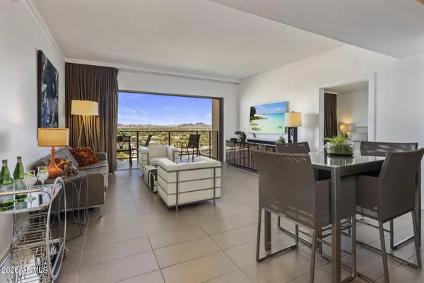 a living room with furniture and a floor to ceiling window