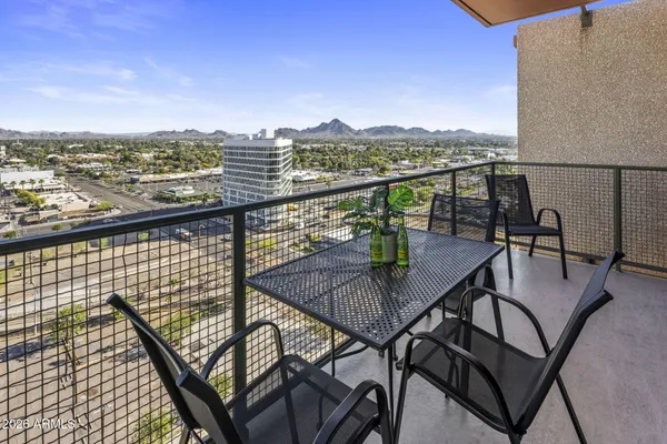 a view of a balcony with an outdoor seating