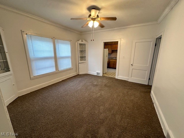 1612 Hillcrest Road Cleveland, OH 44118 - Photo 19 of 29 Empty room with ornamental molding, dark colored carpet, and ceiling fan