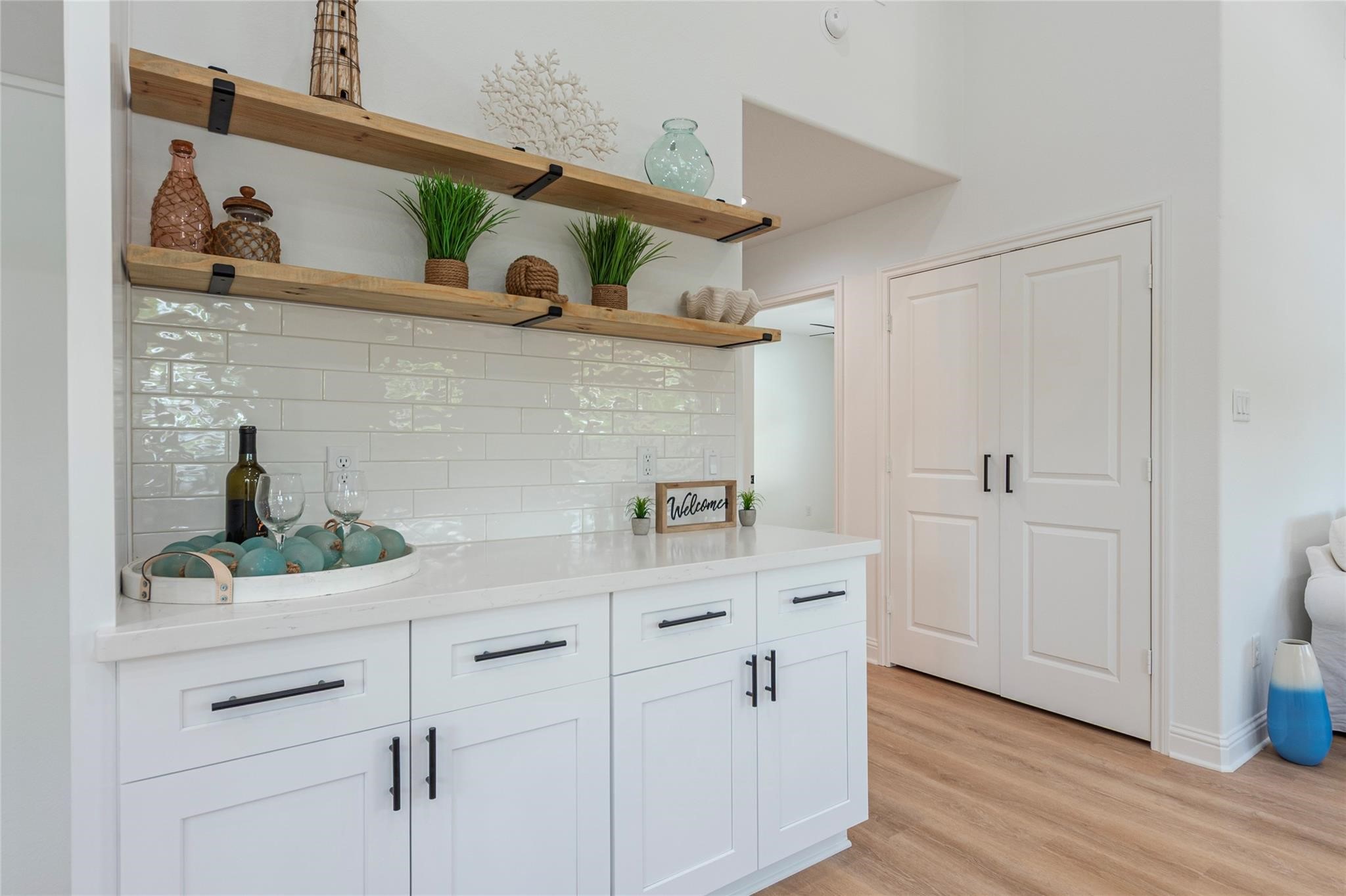 4213 Houx Street Bacliff, TX 77518 - Photo 11 of 37 a kitchen with stainless steel appliances white cabinets and wooden floor