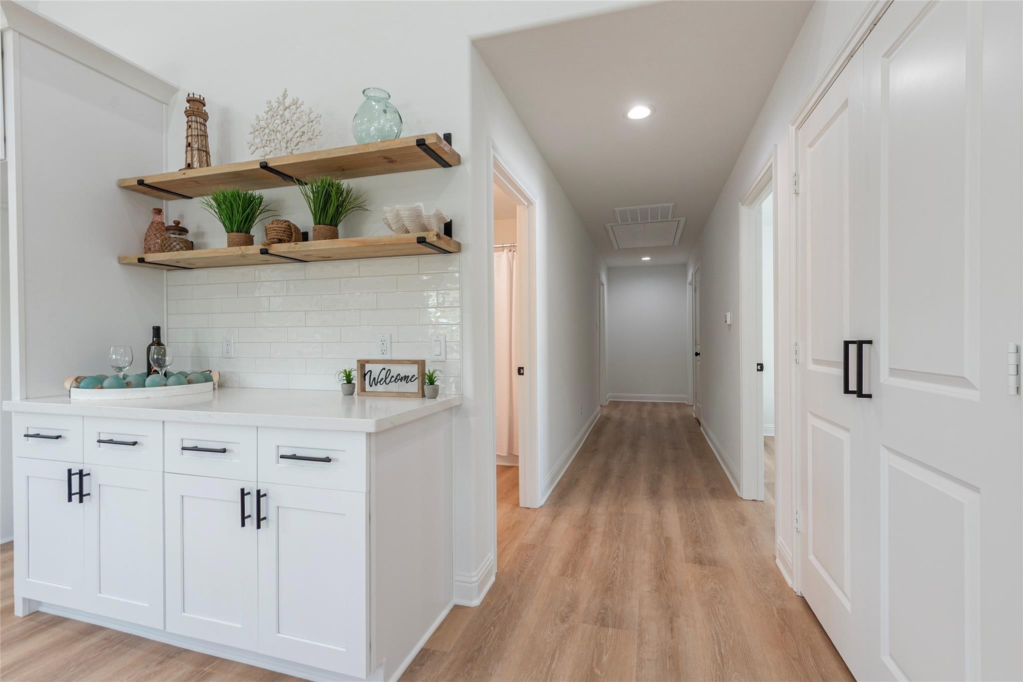 4213 Houx Street Bacliff, TX 77518 - Photo 16 of 37 a view of a hallway with shelves and wooden floor