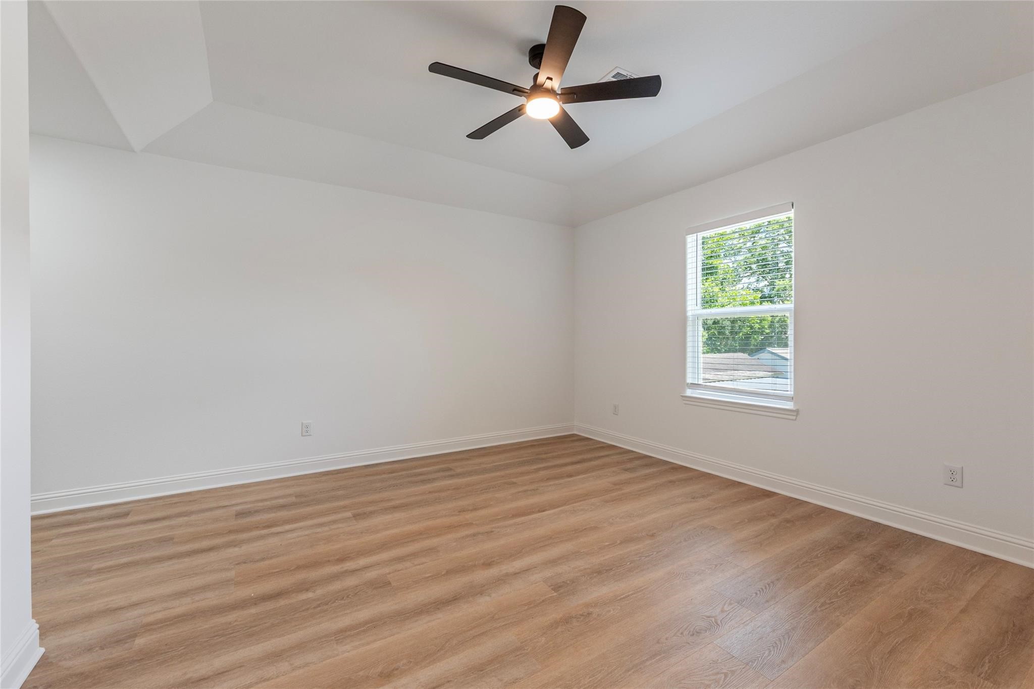 4213 Houx Street Bacliff, TX 77518 - Photo 31 of 37 an empty room with wooden floor ceiling fan and windows