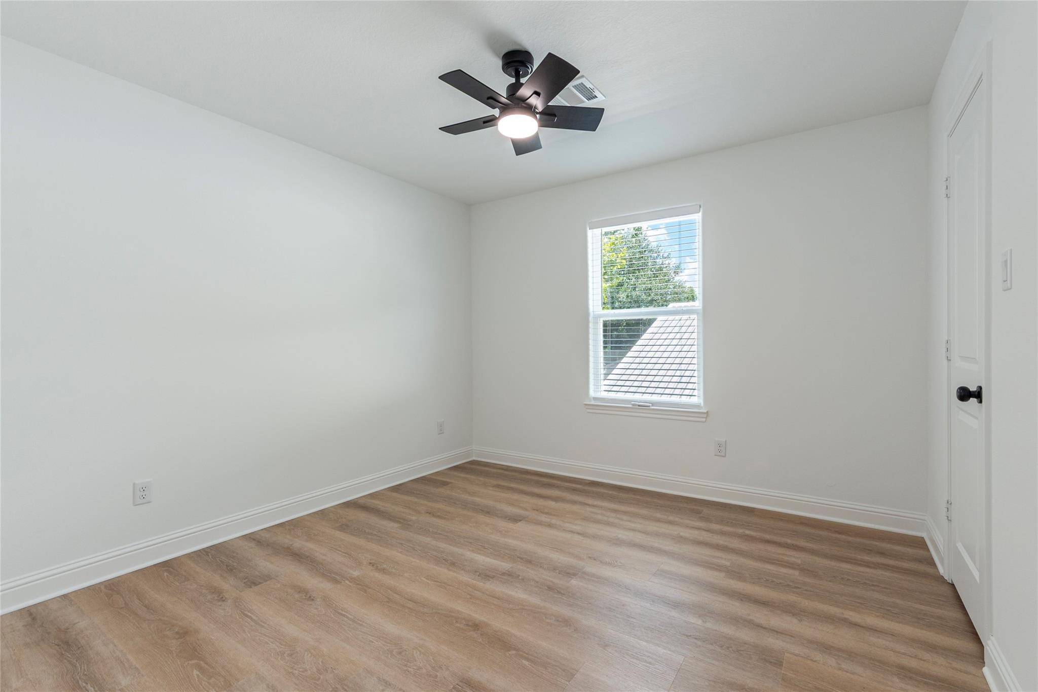 4213 Houx Street Bacliff, TX 77518 - Photo 33 of 37 wooden floor in an empty room with a window