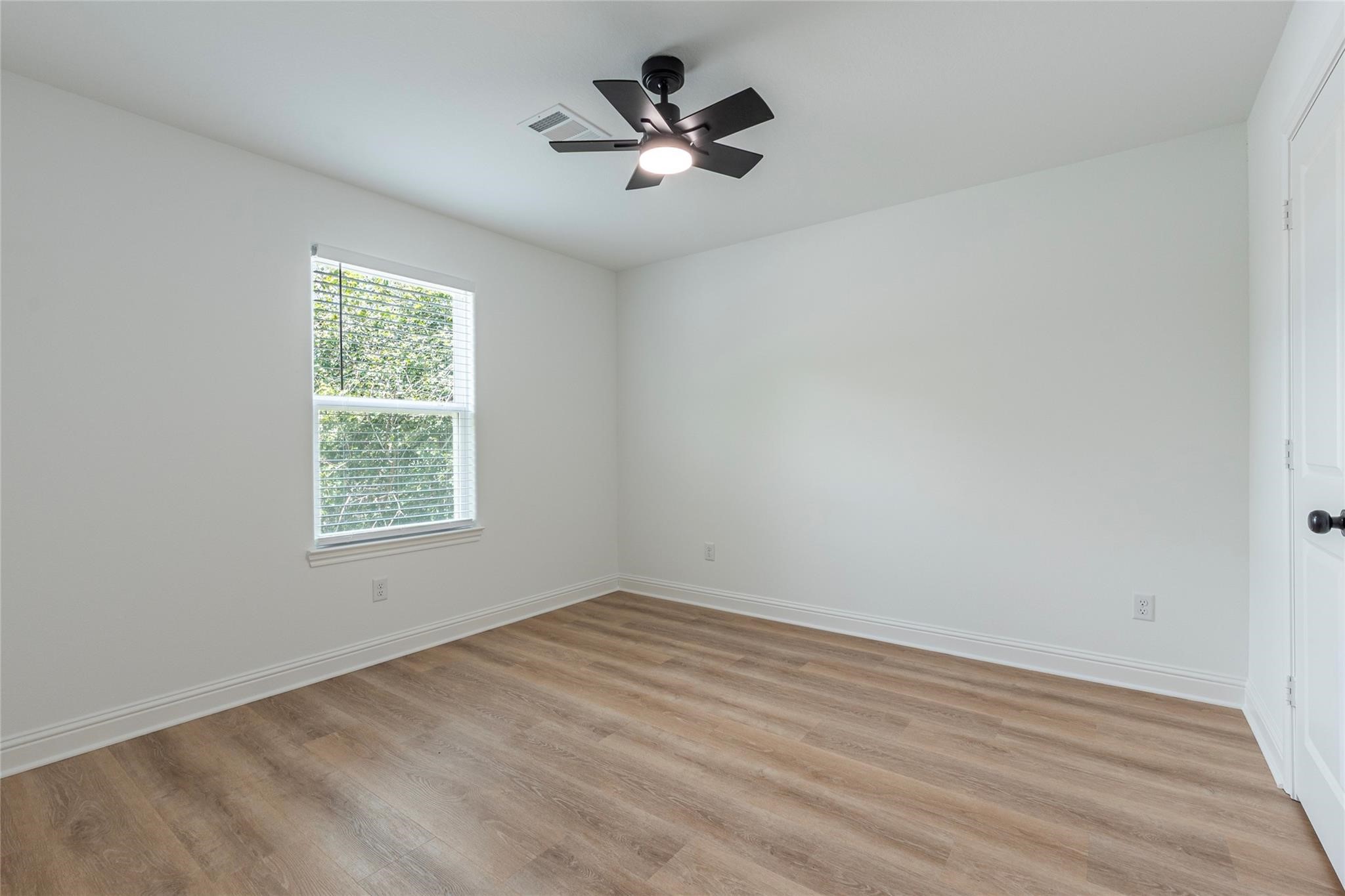 4213 Houx Street Bacliff, TX 77518 - Photo 35 of 37 wooden floor in an empty room with a window