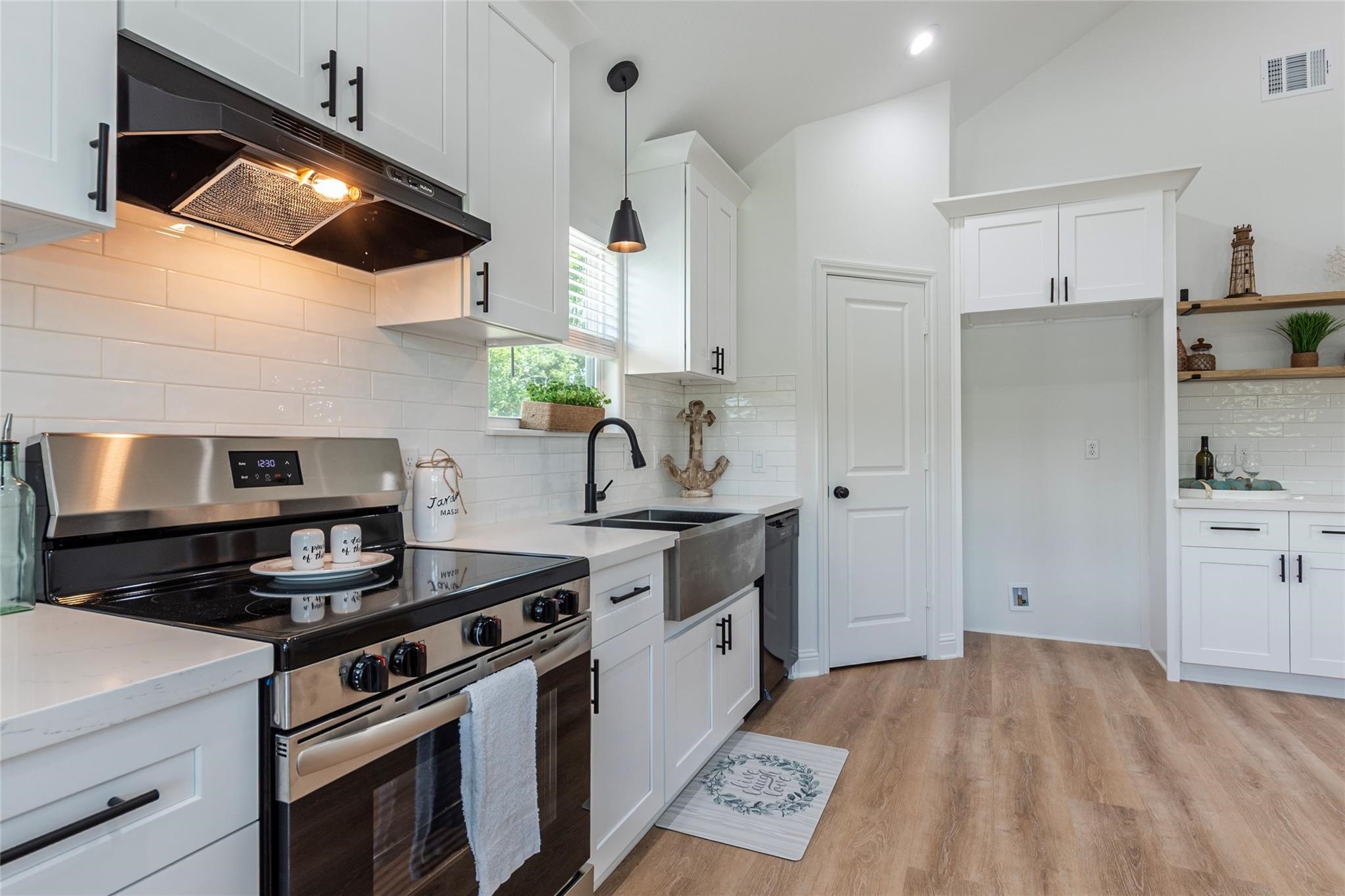 4213 Houx Street Bacliff, TX 77518 - Photo 4 of 37 a kitchen with stainless steel appliances a stove a sink and a refrigerator