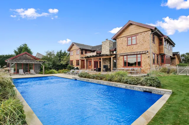 a view of a house with pool and yard