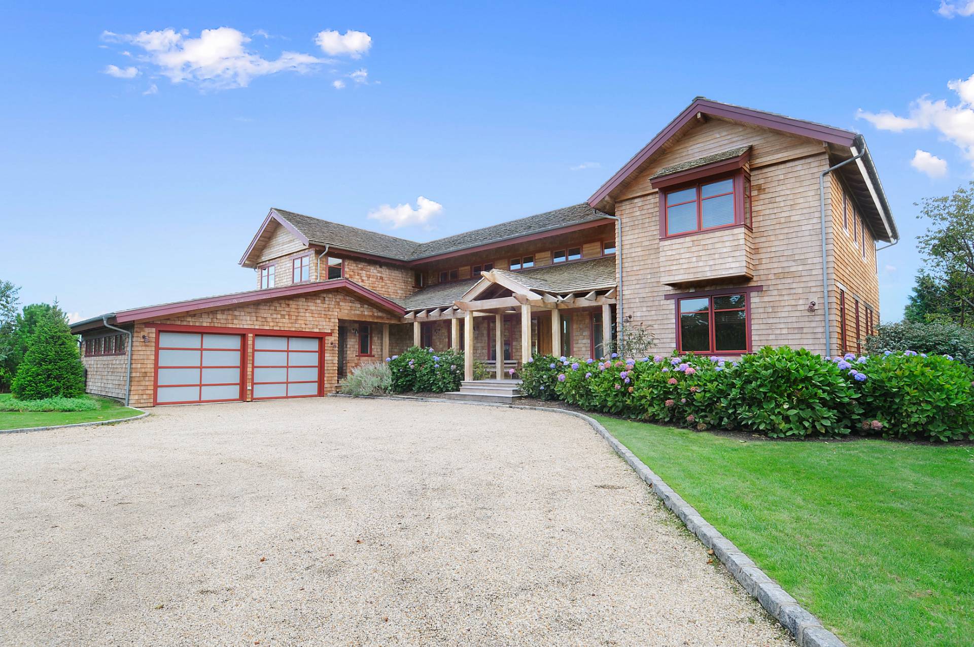 807 Halsey Lane Bridgehampton, NY 11932 - Photo 2 of 9 a front view of a house with a yard and garage