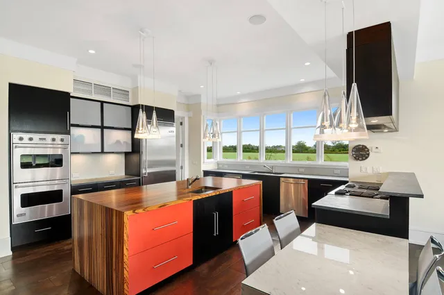 a kitchen with stainless steel appliances a sink a stove and a refrigerator