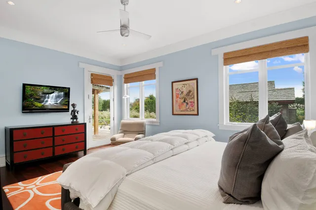 a bedroom with a bed and a television