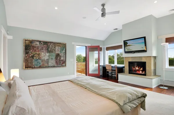 a spacious bedroom with a large bed and a fireplace
