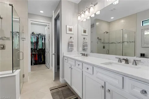 a bathroom with a double vanity sink and a mirror