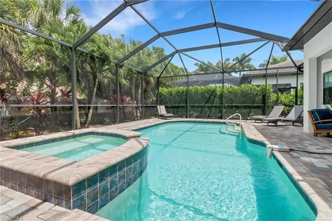 a view of a backyard with swimming pool