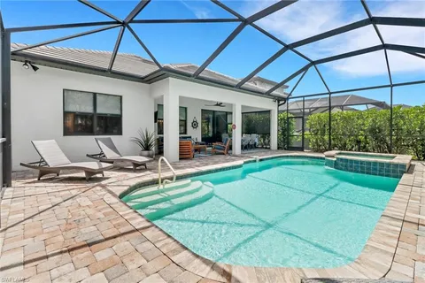 a view of a patio with a table and chairs under an umbrella