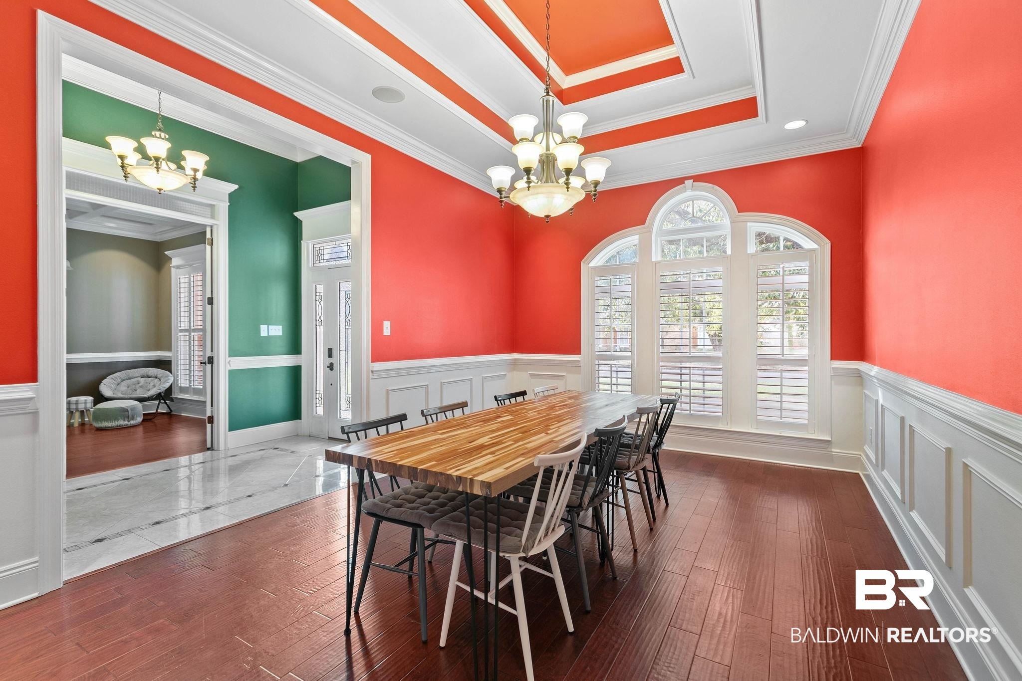 3668 Claridge Road North Mobile, AL 36608 - Photo 30 of 100 Dining area with a chandelier, dark wood finished floors, healthy amount of natural light, ornamental molding, and a tray ceiling