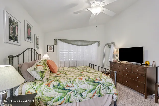 a view of a livingroom with workspace and a window