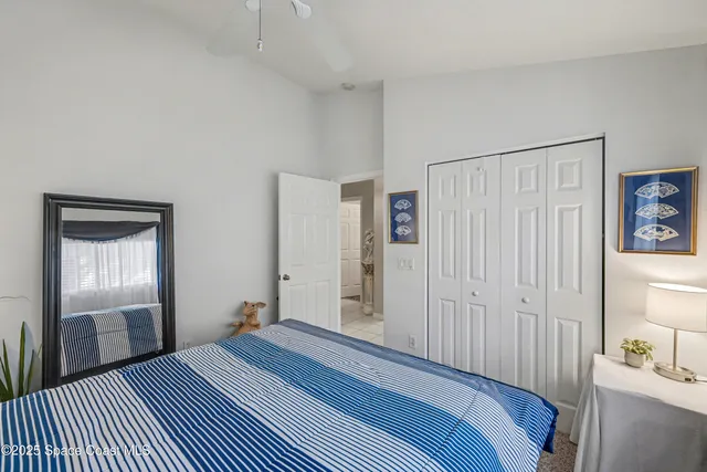 a living room with furniture a flat screen tv and a wall painting